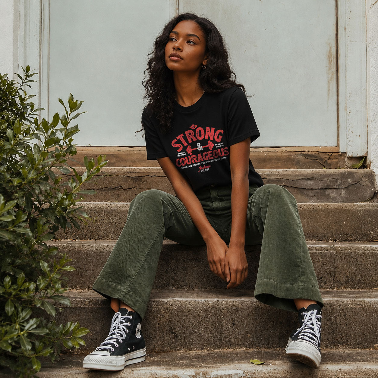 Unisex softstyle T-shirt by Printify with "Be Strong and Courageous" slogan, featuring a comfortable fit and casual style.