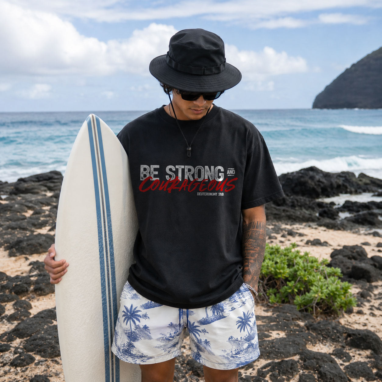 Unisex Softstyle T-Shirt by Printify featuring "Be Strong and Courageous" slogan in bold lettering on soft fabric.