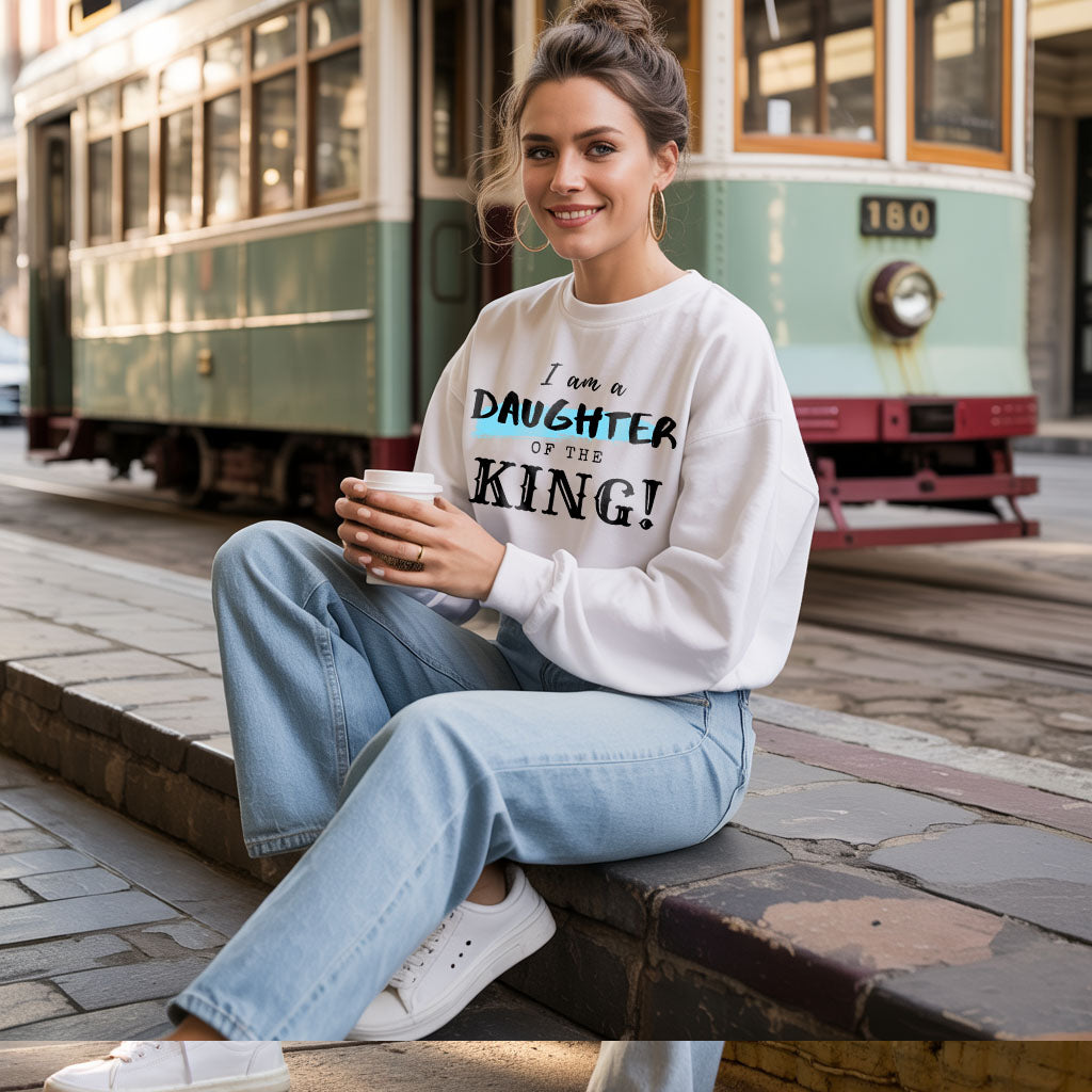 Unisex midweight softstyle fleece crewneck sweatshirt with "I Am a Daughter of the King" printed on the front, in a comfortable fit.