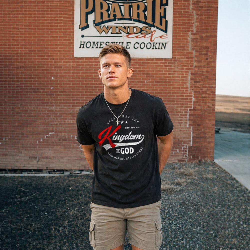 Unisex softstyle T-shirt with religious quote "Seek First the Kingdom of God" in black text on white fabric by Printify
