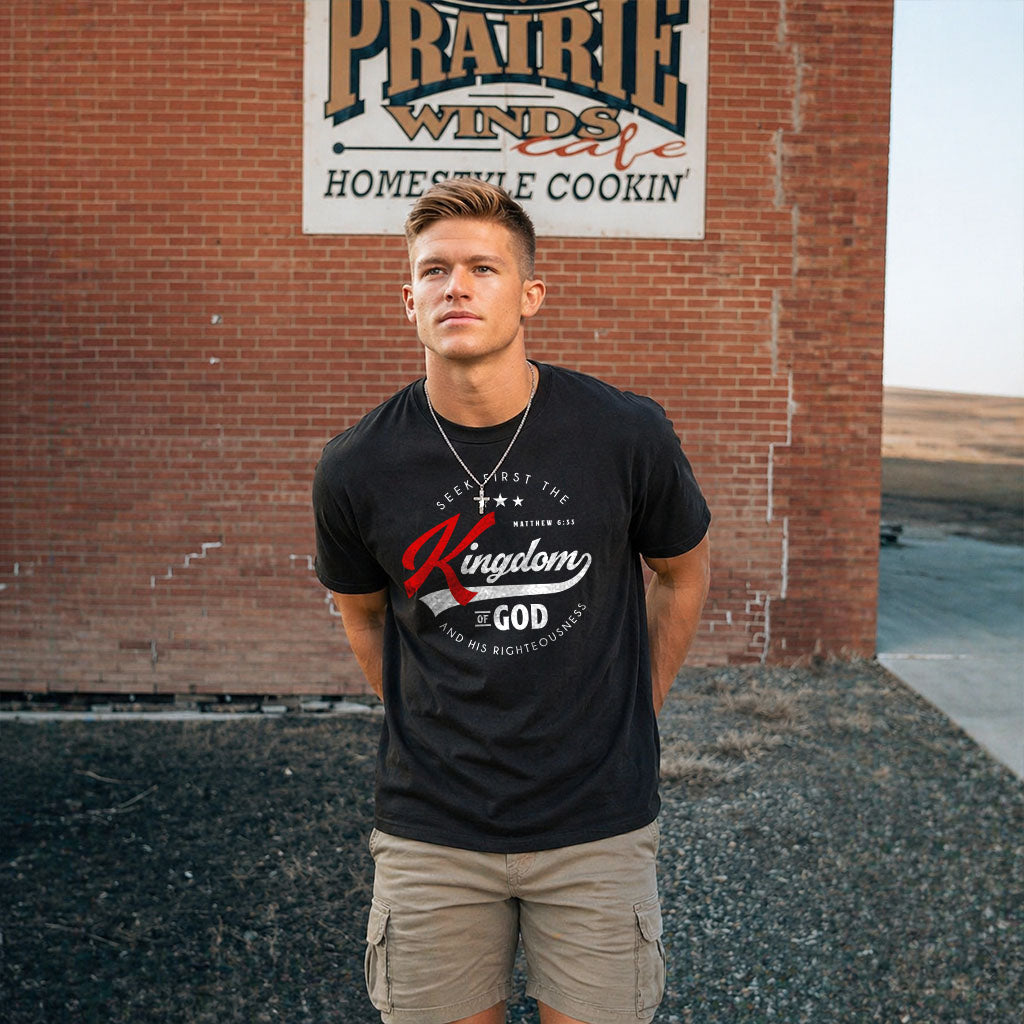 Unisex softstyle T-shirt with religious quote "Seek First the Kingdom of God" in black text on white fabric by Printify