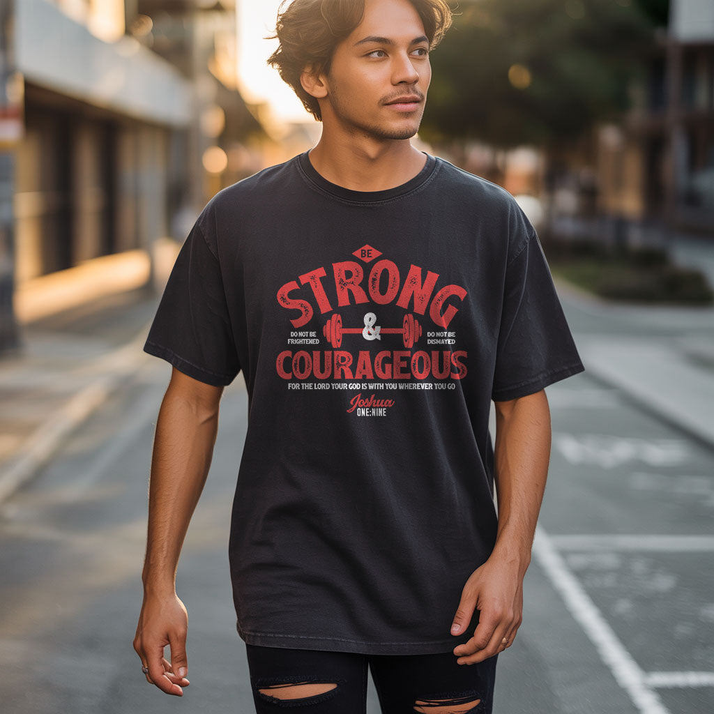 Unisex softstyle T-shirt by Printify featuring a "Be Strong and Courageous" design, in soft fabric, displayed flat.
